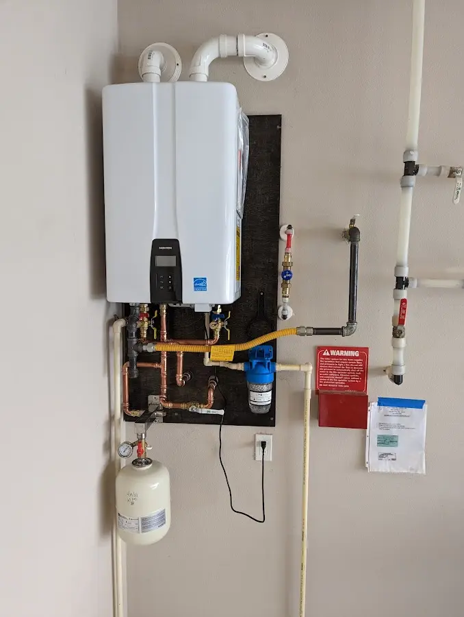 Professional plumber installing copper piping in a LaSalle home